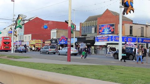 Blackpool Promenade view of street traffic - English double decker buses, tram and Cinderella carriage. England, Promenade, October 2016