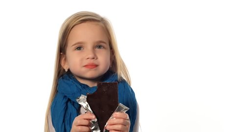 little girl a blonde eats a chocolate