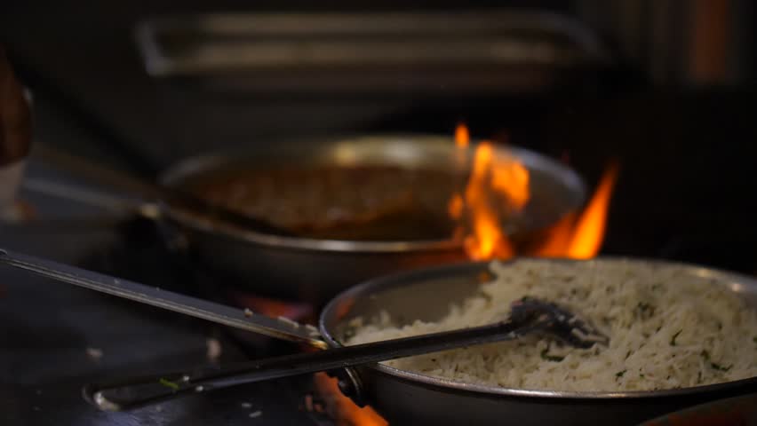 Indian Food Indian Restaurant chef preparing masala food in slow motion. A stir fry meal being prepared in a hotel or restaurant kitchen.  Royalty-Free Stock Footage #32443582