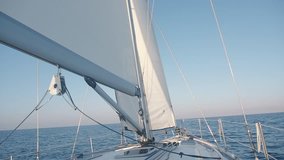 Front of the beautiful white sailing boat in the ocean. Yacht nose with white sail. Beautiful sea view on the sunny day