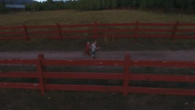 Two little boys holding hands and running down a country road.