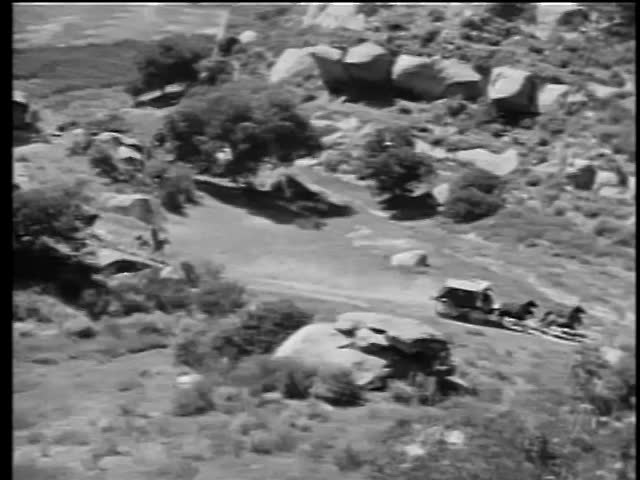 High angle view of Native Americans on horses chasing horsedrawn carriage