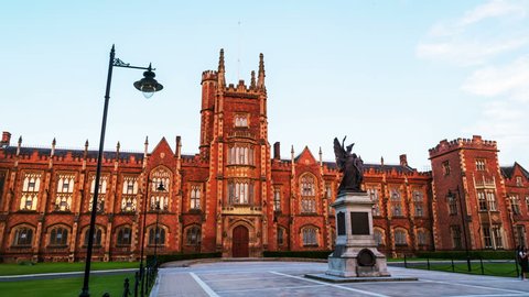Belfast, UK. The Lanyon Building, Queen's University Belfast, Northern Ireland, UK. Time-lapse in the evening with cloudless blue sky. Moving hyperlapse