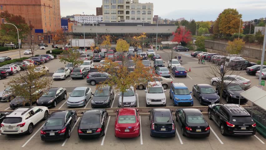 A daytime overcast Autumn exterior (DX) establishing shot of a high-end grocery store.  	
