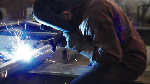 welder working and soldering iron with mask-slider shot