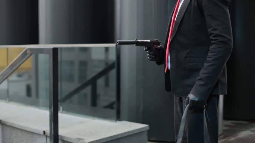 In the hands of a pistol with a silencer.