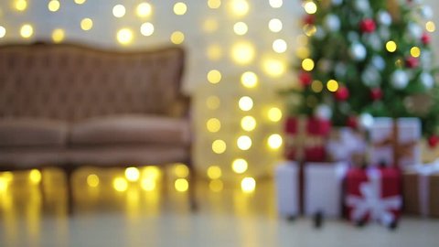 christmas background - decorated living room with christmas tree, gift boxes and lights
