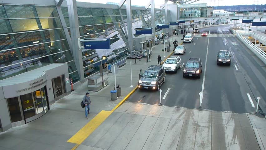 PORTLAND, OREGON AIRPORT - CIRCA JANUARY 2013: Cars driving and people traveling