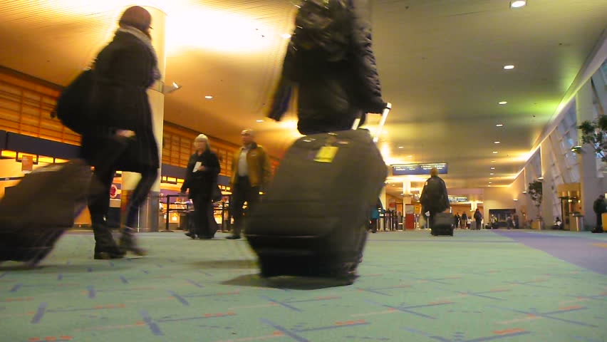 PORTLAND, OREGON AIRPORT - CIRCA JANUARY 2013: People walking with luggage
