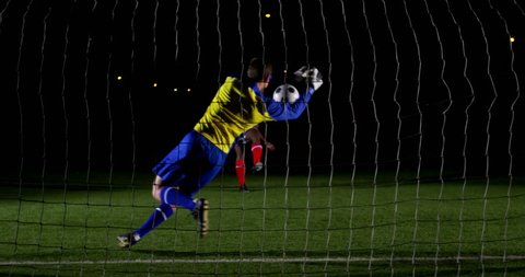 Goalkeeper catching a soccer ball in the playing field 4k Stockvideó