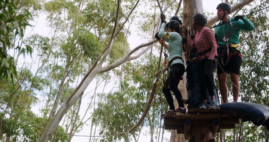 Woman swinging on a rope in the forest 4k