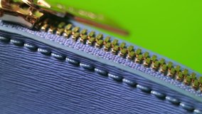 Bag zipper close up on a green background. Element for creative fashion concept. Keying ready. Full HD video.