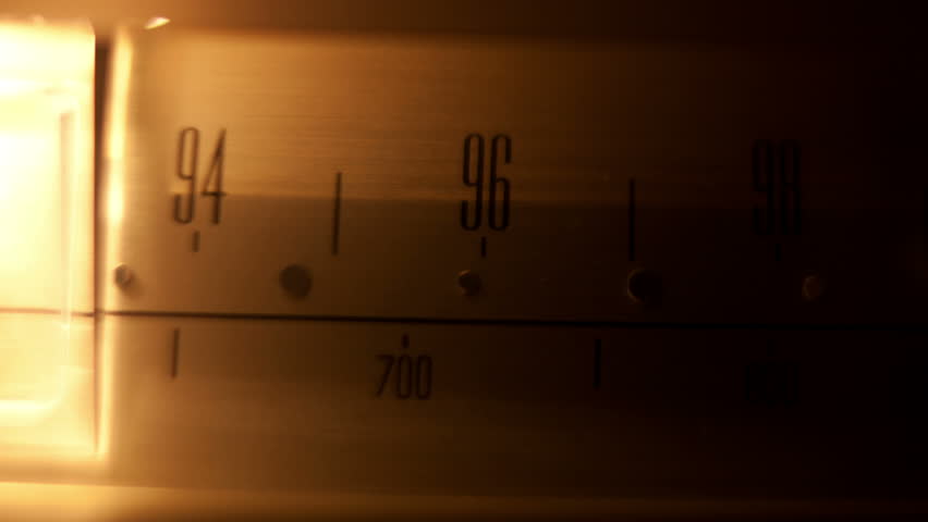 a glowing radio with the marker running through the different stations and frequencies