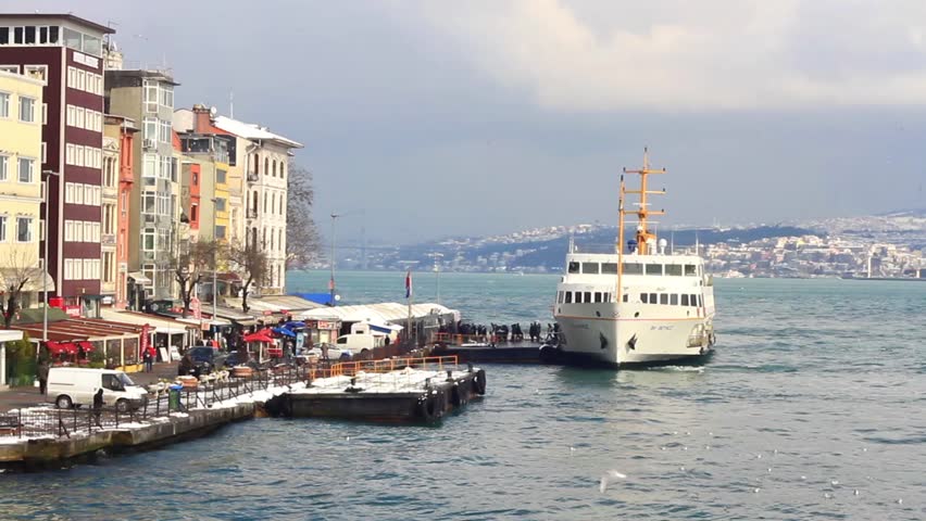 Karakoy Ferry Port with a berthed city passenger ship in a snowy winter day.