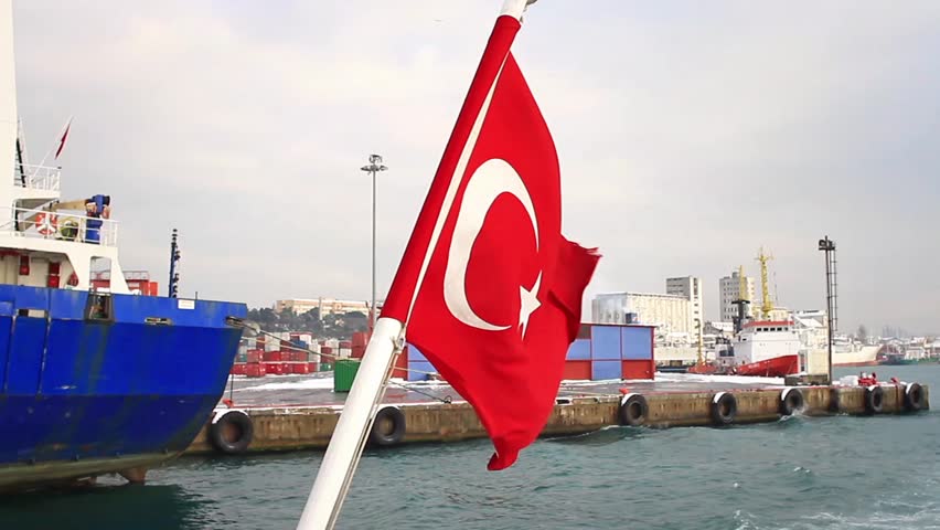 Seaport as seen from the waterside with a Turkish Flag waving. An empty