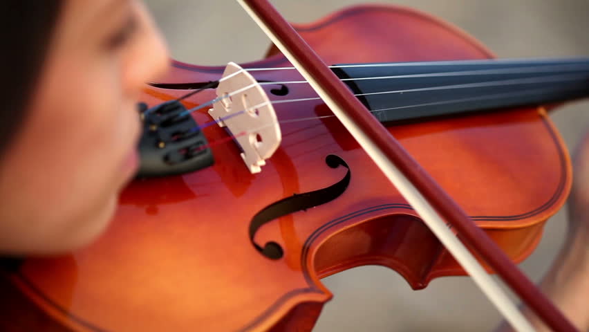 girl playing the violin in extremely close up shot
