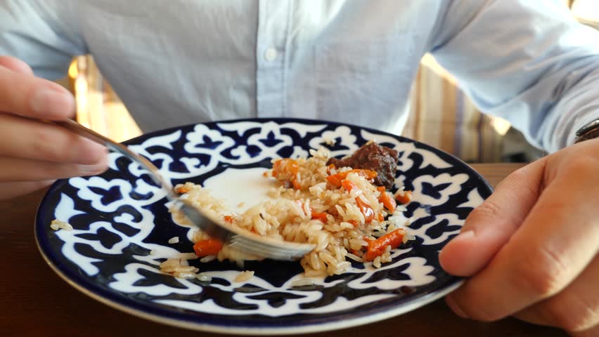 someone eats pilaf in a restaurant of national cuisine. 4k, slow motion