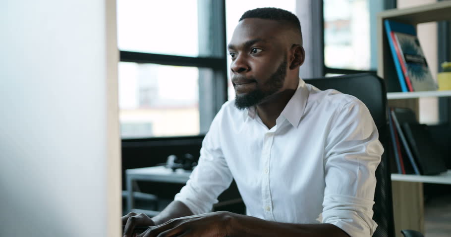 Serious handsome black man working use computer looking in monitor screen office technology african american businessman casual communication successful person portrait smart business Slow Motion Shot | Shutterstock HD Video #32500777