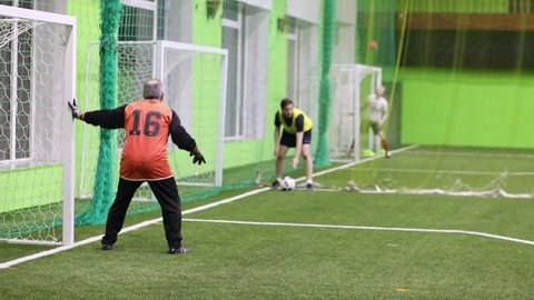 MOSCOW, RUSSIA - JAN 23, 2017: Players are waiting for a blow from the corner on indoors field in club Shakhtar in Sokolniki, slow motion