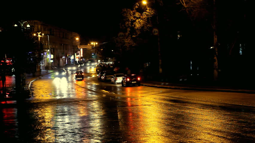 Beautiful timelapse night view of the city road with cars. Rainy night. 