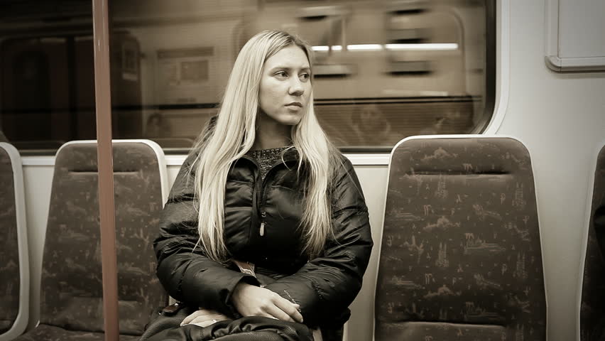 Beautiful young woman alone on subway train