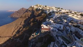 Aerial drone video of beautiful picturesque village of Fira built on top of a cliff with breathtaking view, Santorini volcanic island, Cyclades, Greece