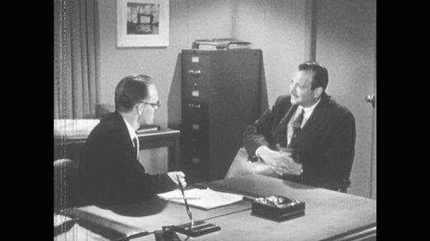 1950s: Men sit at desk and converse. Men shake hands. Men continue talking. Women at desk talk. Woman speaks into phone.