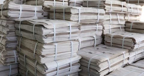 Huge piles of printed newspapers printing shop