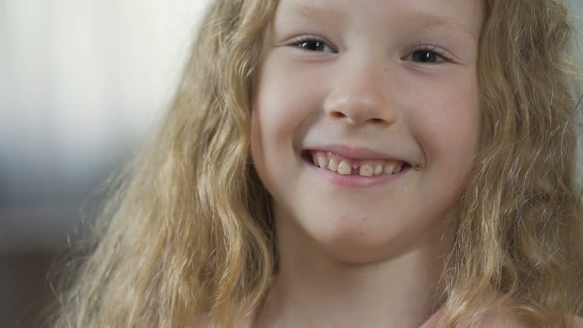 Little girl smiling and laughing into camera, stomatology and healthcare | Shutterstock HD Video #32526070