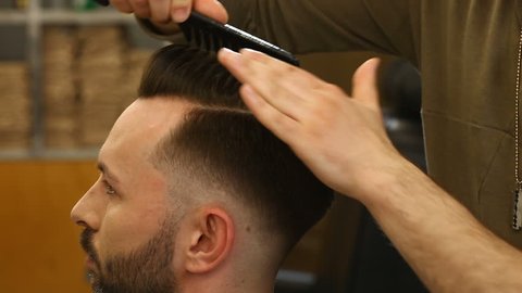Barber make hair with comb for hair.