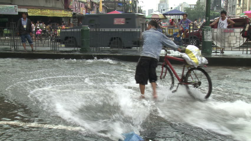 MANILA, PHILIPPINES - AUGUST 2012: Flood Waters Surge Through Streets Of Manila