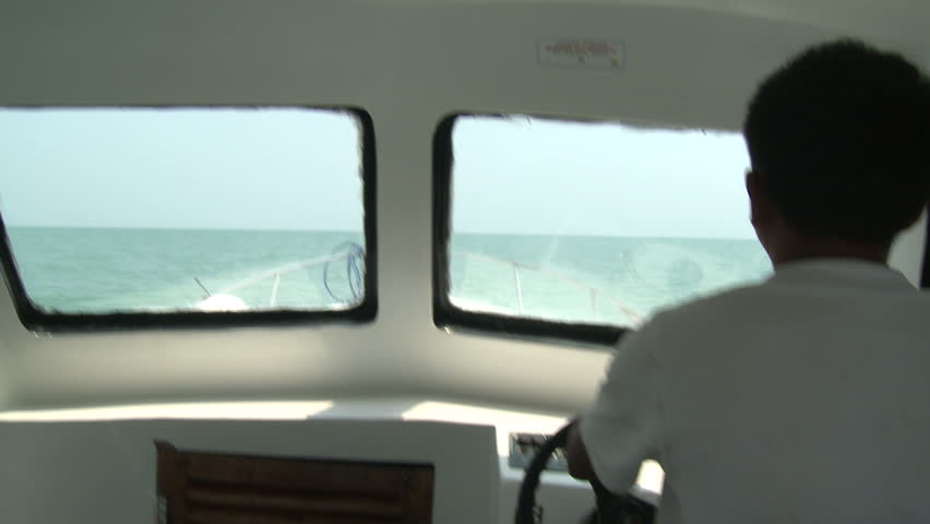 Man Driving Speed Boat In Open Ocean. Shot on Sony EX1 XDCAM en route to Anak