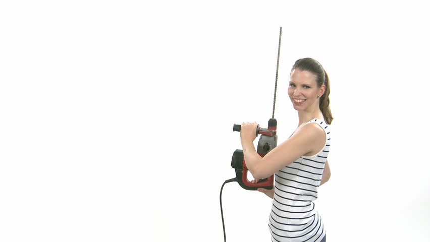 Young craftswoman with a power drill in front of white background