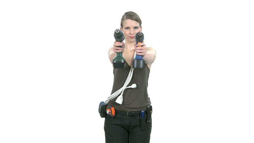 Young craftswoman with two power drills in front of white background