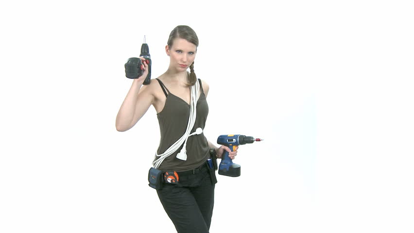 Young craftswoman with two power drills in front of white background