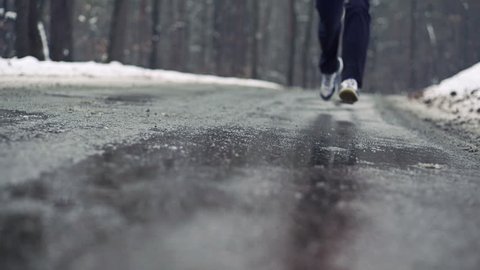 Jogger running on wet road, super slow motion, shot at 240fps
