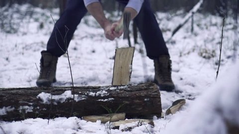 Lumberjack chopping wood in the winter, super slow motion, shot at 240fps
