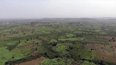 Aerial footage of open green farm lands in Abuja Nigeria