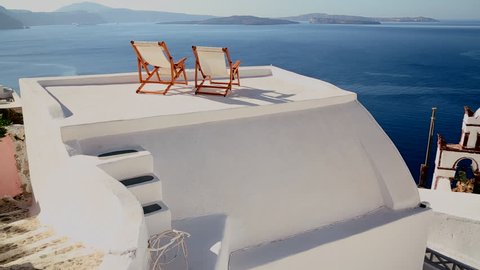 SANTORINI, GREECE 2012 Pan across deck chairs sit on a beautiful balcony in the Greek Islands.