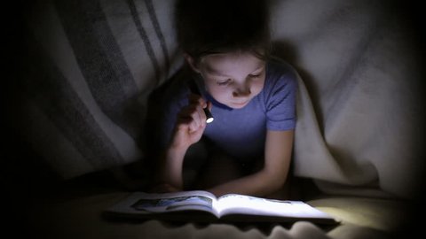 Little Girl Reading Book Under Blanket Stock Footage Video (100% ...