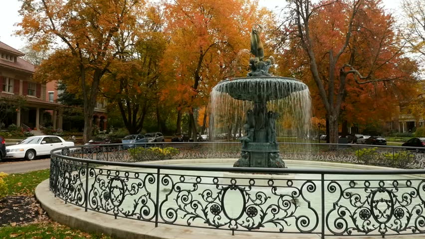 St James Fountain in charming Old Louisville Kentucky USA. Autumn Fall.  Neighborhood of quaint Victorian homes houses.  Establishing shot.