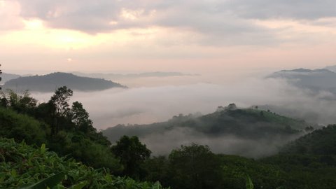 Landscape with fog in the morning at the  mountain,Heavy fog drifting over the river in the morning, view from the peak,majestic sunrise or sunset in the mountains landscape,dramatic sky.