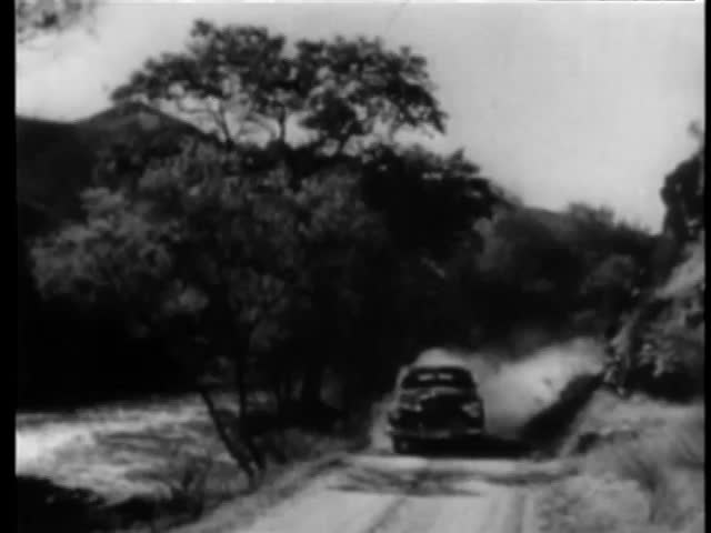 1940s car riding up side of country road