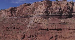 Aerial climb up cliff side to reveal Zion mountain