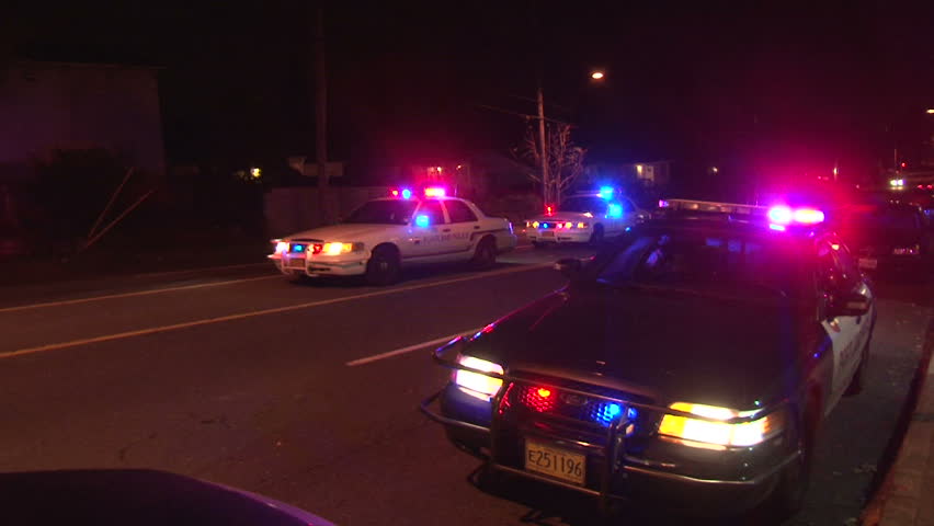 PORTLAND, OREGON - CIRCA DECEMBER 2012: Police lights flashing at night downtown