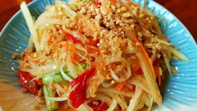 Papaya Salad, Som Tum, Tum Thai, Asia Salad made of Papaya and Vegetables Thai Style served in the Restaurant, Asian Traditional Food Background 4k Video Footage Clip