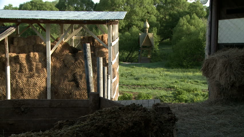 Shed of hay and wooden well on summer day view