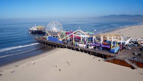 Aerial Drone Stock Video of Santa Monica Pier theme park on the ocean and Ferris Wheel