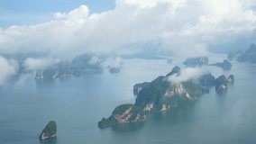 4K. top view aerial video of beauty nature landscape with many small island around Phuket island , Thailand. footage from window of airplane between flight over the cloud