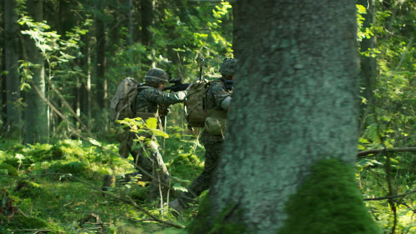 Squad of Five Fully Equipped Soldiers in Camouflage on a Reconnaissance Military Mission, Rifles in Firing Position. They